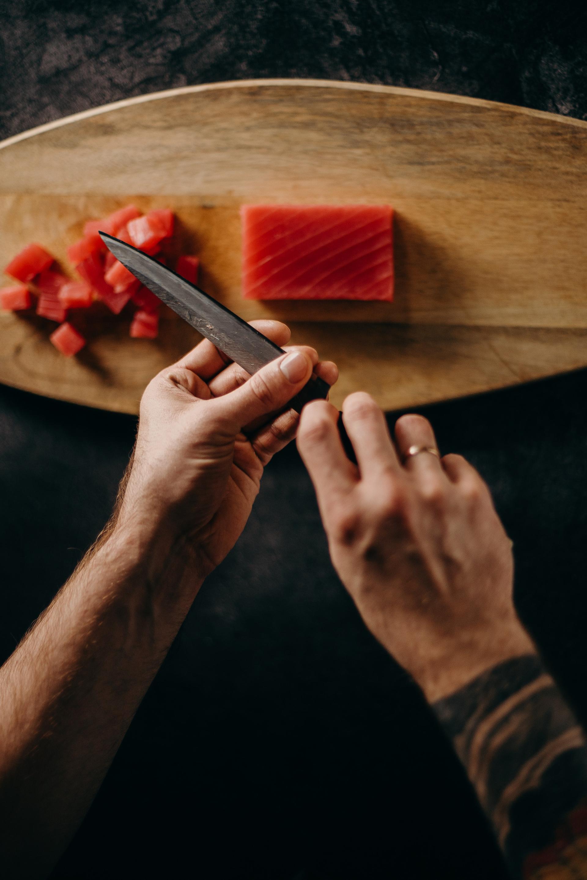 Hands chopping herbs on a cutting board